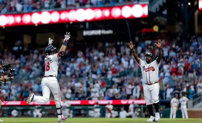 Atlanta Braves' Mike Yastrzemski (18) reacts with Braves third base coach Tommy Watkins (84) while rounding the bases after hitting a two-run home run against the Washington Nationals during the fifth inning of a baseball game, Thursday, July 30, 2026, in Atlanta. (AP Photo/Erik S. Lesser)