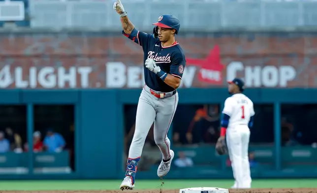 Washington Nationals' Daylen Lile reacts while rounding the bases after hitting a solo home run against the Atlanta Braves during the second inning of a baseball game, Thursday, July 30, 2026, in Atlanta. (AP Photo/Erik S. Lesser)
