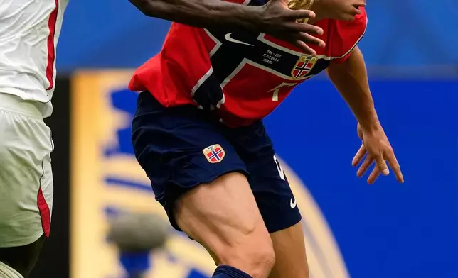 Norway's Erling Haaland, right, controls the ball next to England's Marc Guehi during the World Cup quarterfinal soccer match between Norway and England in Miami Gardens, Fla., Saturday, July 11, 2026. (AP Photo/Rebecca Blackwell)