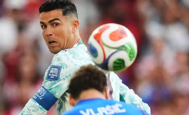 Portugal's Cristiano Ronaldo (7) watches as Croatia's Nikola Vlasic (13) heads the ball during the World Cup round of 32 soccer match between Portugal and Croatia in Toronto, Thursday, July 2, 2026. (Nathan Denette/The Canadian Press via AP)