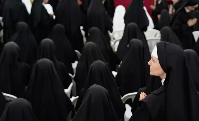 Nuns attend a consecration ceremony for four new bishops in a tent set up outside the Society of St. Pius X seminary, in Econe, Switzerland, Wednesday, July 1, 2026. (AP Photo/Baz Ratner)
