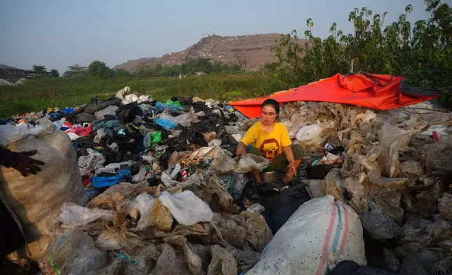 Nur Wencih, a waste picker, sorts recyclable items of her boarding house near the Bantargebang landfill on the outskirts of Jakarta, Indonesia, Monday, July 6, 2026. (AP Photo/Tatan Syuflana)