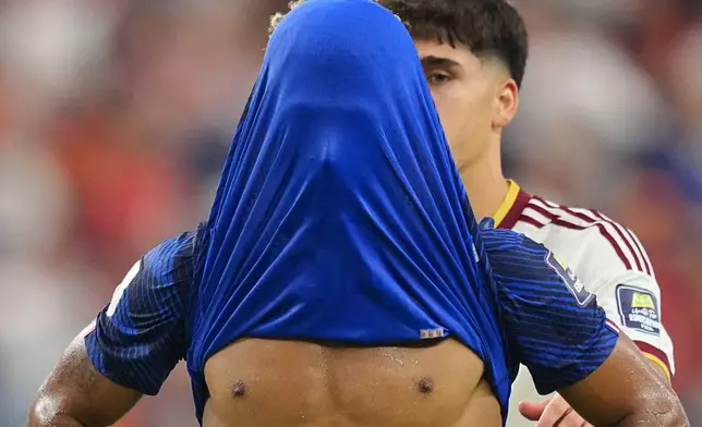 France's Desire Doue covers his face after his side's lost against in a World Cup semifinal soccer match in Arlington, Texas, near Dallas, Tuesday, July 14, 2026. (AP Photo/Julio Cortez)