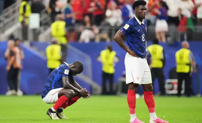 France's Dayot Upamecano, left, and Aurelien Tchouameni (8) stand dejected after the World Cup semifinal soccer match between France and Spain in Arlington, Texas, near Dallas, Tuesday, July 14, 2026.(AP Photo/Eric Gay)
