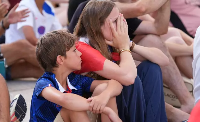 Marie Dalnard and her brother Alexander, 11, watch as France falls behind Spain at a World Cup semifinal soccer watch party, Tuesday, July 14, 2026, in Miami Beach, Fla. (AP Photo/Marta Lavandier)