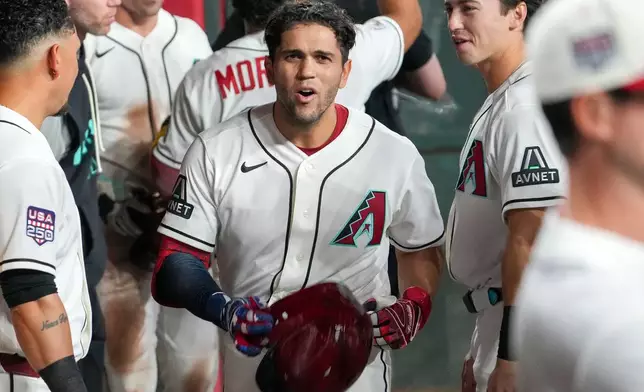 Arizona Diamondbacks' Adrian del Castillo, center, celebrates with teammates after hitting a three-run home run during the first inning of a baseball game against the Milwaukee Brewers, Saturday, July 4, 2026, in Phoenix. (AP Photo/Darryl Webb)
