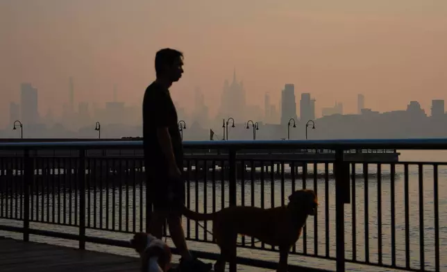 The New York City skyline is seen through a cover of wildfire smoke, in Jersey City, N.J., Friday, July 17, 2026. (AP Photo/Ryan Murphy)