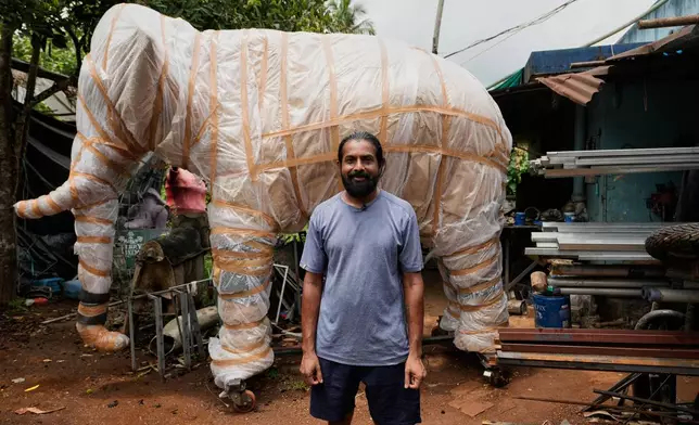 Prasanth Prakashan, a mechanical engineer, poses in front of a robotic elephant at his backyard workshop in Chalakudy, in the southern Indian state of Kerala, Friday, May 22, 2026. (AP Photo/Aijaz Rahi)