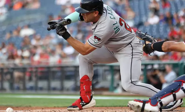 Arizona Diamondbacks' Adrian del Castillo lays down a sacrifice bunt during the second inning of a baseball game against the Washington Nationals, Friday, July 24, 2026, in Washington. (AP Photo/Daniel Kucin Jr.)