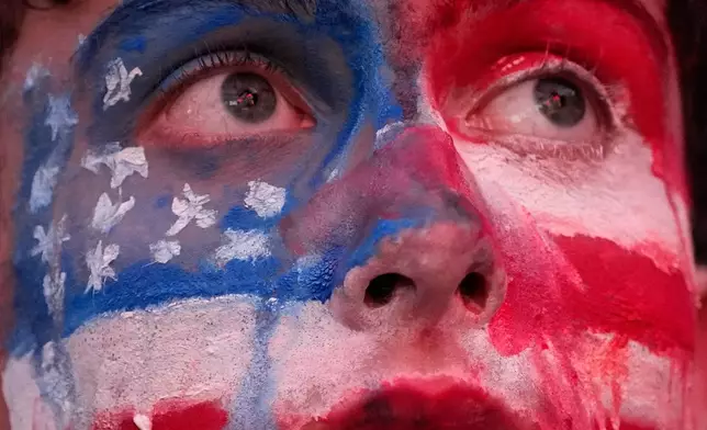 A fan watches the final minutes of a World Cup round of 16 soccer match between the United States and Belgium at the KC Live! entertainment district Monday, July 6, 2026, in Kansas City, Mo. (AP Photo/Charlie Riedel)