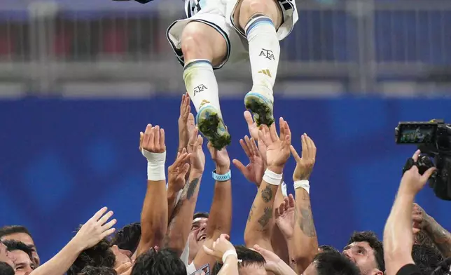 Argentina players toss teammate Lionel Messi (10) into the air as they celebrate after the World Cup round of 16 soccer match between Argentina and Egypt in Atlanta, Tuesday, July 7, 2026. (AP Photo/Jacob Kupferman)