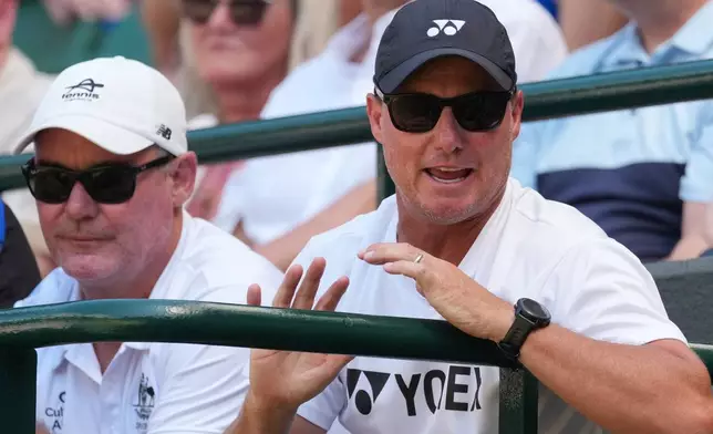 Former tennis player Lleyton Hewitt, right watches his son Cruz Hewitt of Australia against Jordan Lee of the United States in the boys singles final at Wimbledon Tennis Championships in London, Sunday, July 12, 2026. (AP Photo/Dave Shopland )