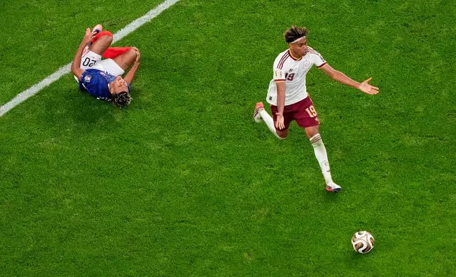 France's Desire Doue (20) falls after being fouled by Spain's Lamine Yamal (19) during the World Cup semifinal soccer match between France and Spain in Arlington, Texas, near Dallas, Tuesday, July 14, 2026. (AP Photo/David J. Phillip)