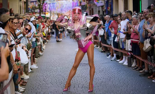 A participant wearing shoes with heels of at least 10 centimeters (3.9 inches) poses in the annual high heel race during Madrid's Pride week, in Madrid, Thursday, July 2, 2026. (AP Photo/Andrea Comas)