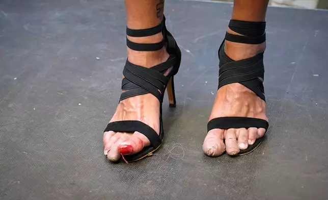 A participant wearing shoes with heels of at least 10 centimeters (3.9 inches) poses after the annual high heel race during Madrid's Pride week, in Madrid, Thursday, July 2, 2026. (AP Photo/Andrea Comas)