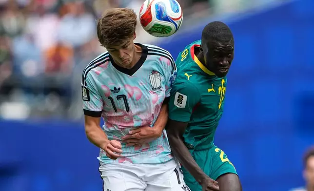 Belgium's Charles De Ketelaere (17) and Senegal's Pape Gueye (26) jumps for the ball during the World Cup round of 32 soccer match between Belgium and Senegal in Seattle, Wednesday, July 1, 2026. (AP Photo/Lindsey Wasson)