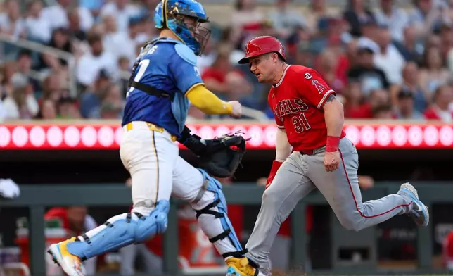 Los Angeles Angels catcher Tyler Heineman scores on a sacrifice fly hit by Vaughn Grissom as Minnesota Twins catcher Ryan Jeffers attempts to field the ball during the fifth inning of a baseball game, Friday, July 10, 2026, in Minneapolis. (AP Photo/Matt Krohn)