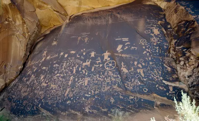 FILE - Newspaper Rock, featuring a rock panel of petroglyphs in the Indian Creek Area, is seen near Monticello, Utah, on July 14, 2016. (AP Photo/Rick Bowmer, File)