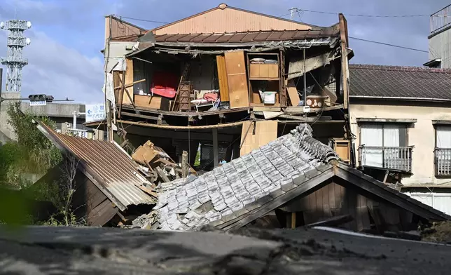 The roof and wall of a building are seen fallen, a day after an earthquake in Yatsushiro, Kumamoto prefecture, Wednesday, July 29, 2026.(Yu Nakajima/Kyodo News via AP)
