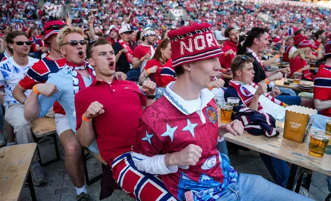 People gather to watch the World Cup soccer match between Brazil and Norway shown on a big screen at Ullevaal Stadium in Oslo, Sunday, July 5, 2026. (Javad Parsa/NTB Scanpix via AP)