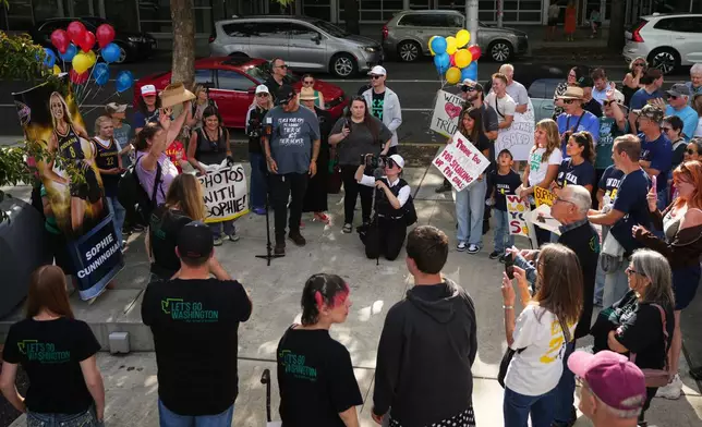 People rally to support Indiana Fever guard Sophie Cunningham after her comments on transgender athletes in women's sports before a WNBA basketball game between the Seattle Storm and the Indiana Fever, Tuesday, July 28, 2026, in Seattle. (AP Photo/Lindsey Wasson)