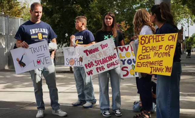 People gather in support of Indiana Fever guard Sophie Cunningham following her comments on transgender athletes before a WNBA basketball game between the Seattle Storm and the Indiana Fever, Tuesday, July 28, 2026, in Seattle. (AP Photo/Lindsey Wasson)