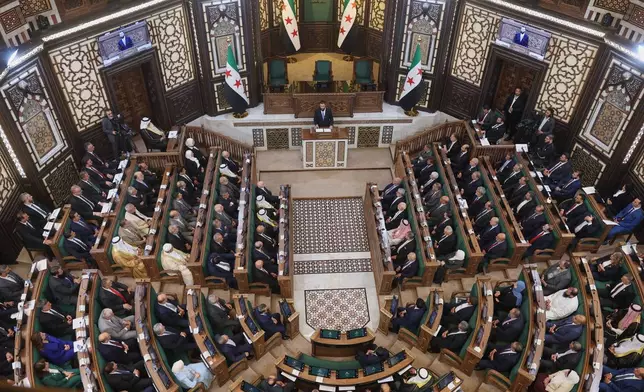 Syrian President Ahmad al-Sharaa addresses the inaugural session of Syria's newly formed People's Assembly, the first since the fall of President Bashar Assad's government, in Damascus, Syria, Sunday, July 12, 2026. (AP Photo/Ghaith Alsayed)