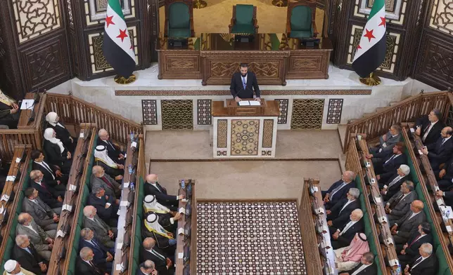 Syrian President Ahmad al-Sharaa addresses the inaugural session of Syria's newly formed People's Assembly, the first since the fall of President Bashar Assad's government, in Damascus, Syria, Sunday, July 12, 2026. (AP Photo/Ghaith Alsayed)