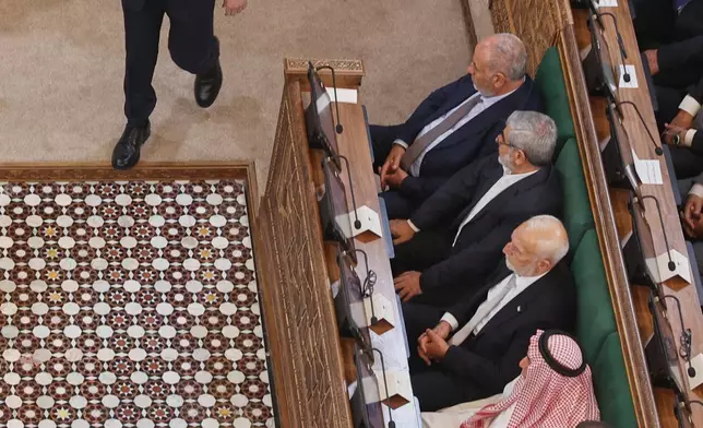 Syrian President Ahmad al-Sharaa walks through the chamber after addressing the inaugural session of Syria's newly formed People's Assembly, the first since the fall of President Bashar Assad's government, in Damascus, Syria, Sunday, July 12, 2026. (AP Photo/Ghaith Alsayed)