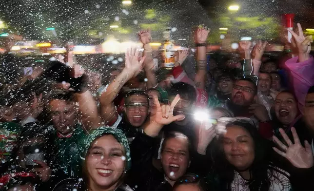 Fans celebrate on Reforma Ave., near the Angel of Independence monument in Mexico City, after Mexico's Julian Quinones scored against Ecuador during the World Cup round of 32 soccer match, Tuesday, June 30, 2026. (AP Photo/Marco Ugarte)
