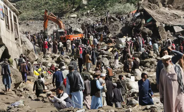 Residents and rescue workers inspect buildings damaged by heavy flooding in the eastern province of Nuristan, Afghanistan, Tuesday, July 21, 2026. (AP Photo/Wahidullah Kakar)