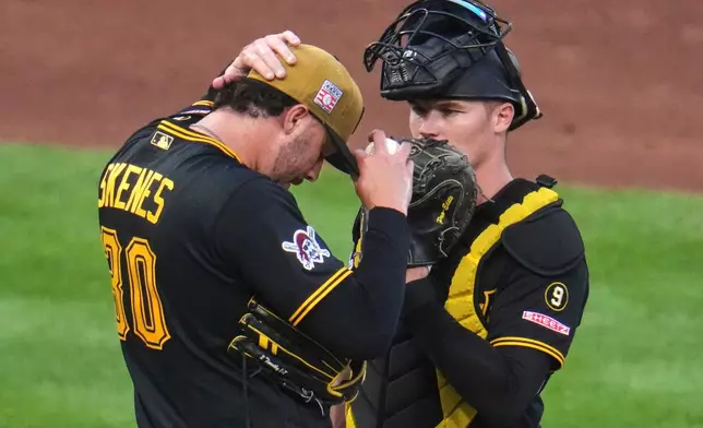 Pittsburgh Pirates pitcher Paul Skenes, left, and catcher Henry Davis, right, talk on the mound during the fifth inning of a baseball game against the Chicago Cubs in Pittsburgh, Saturday, July 25, 2026. (AP Photo/Gene J. Puskar)