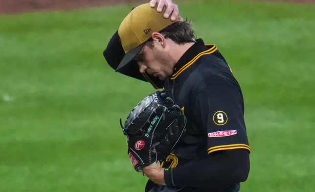 Pittsburgh Pirates pitcher Isaac Mattson walks off the mound after handing the ball to manager Don Kelly during the sixth inning of a baseball game against the Chicago Cubs in Pittsburgh, Saturday, July 25, 2026. (AP Photo/Gene J. Puskar)