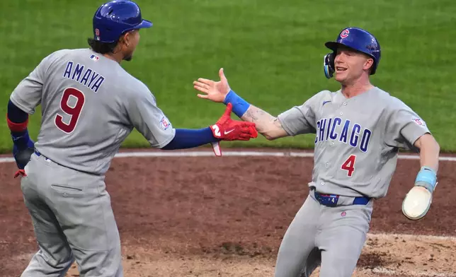 Chicago Cubs' Pete Crow-Armstrong (4) and Miguel Amaya (9) celebrate after scoring on a single by Seiya Suzuki off Pittsburgh Pirates pitcher Paul Skenes during the fifth inning of a baseball game in Pittsburgh, Saturday, July 25, 2026. (AP Photo/Gene J. Puskar)