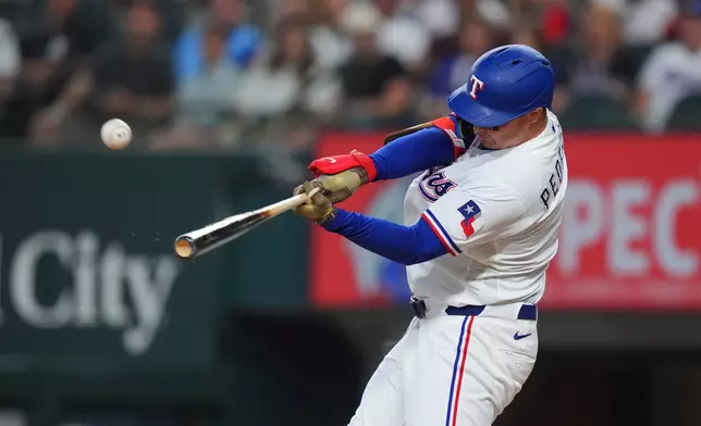 Texas Rangers designated hitter Joc Pederson hits a home run during the first inning of a baseball game against the Chicago White Sox, Monday, July 20, 2026, in Arlington, Texas. (AP Photo/LM Otero)