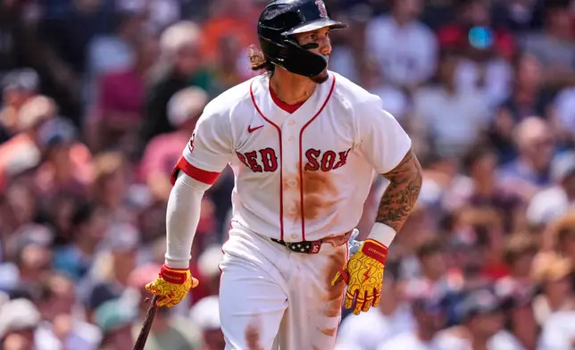 Boston Red Sox's Jarren Duran watches the flight of his sacrifice fly, which scored Caleb Durbin, in the third inning during the first baseball game of a doubleheader against the Baltimore Orioles, Wednesday, July 22, 2026, in Boston. (AP Photo/Charles Krupa)