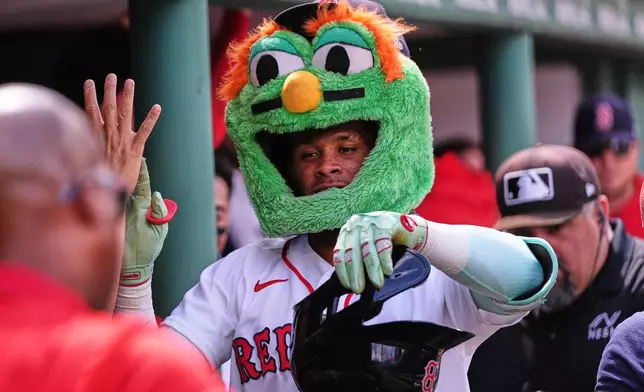 Boston Red Sox's Ceddanne Rafaela is congratulated after his solo home run in the fourth inning during the first baseball game of a doubleheader against the Baltimore Orioles, Wednesday, July 22, 2026, in Boston. (AP Photo/Charles Krupa)