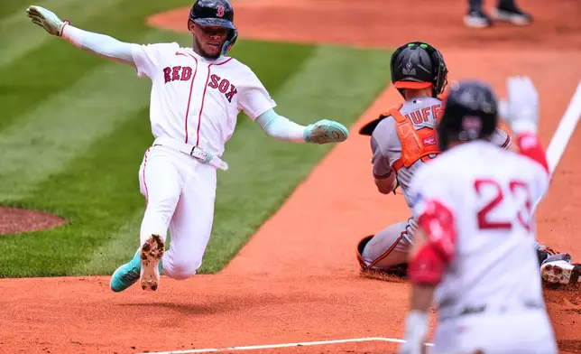 Boston Red Sox's Ceddanne Rafaela scores on a two-rn single by Caleb Durbin in the first inning during the first baseball game of a doubleheader against the Baltimore Orioles, Wednesday, July 22, 2026, in Boston. (AP Photo/Charles Krupa)