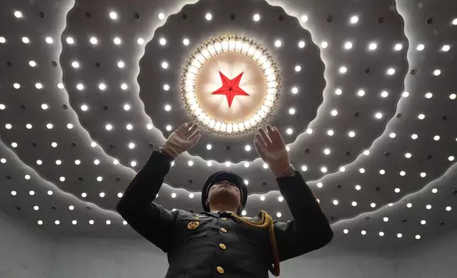 A military band conductor leads during a ceremony to mark the 105th anniversary of the founding of the Chinese Communist Party at the Great Hall of the People in Beijing, Wednesday, July 1, 2026. (AP Photo/Ng Han Guan)