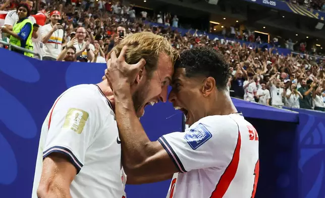 England's Harry Kane (9) celebrates after scoring a goal next to teammate Jude Bellingham (10) during the World Cup round of 32 soccer match between England and Congo in Atlanta, Wednesday, July 1, 2026. (Jason Getz/Atlanta Journal-Constitution via AP)