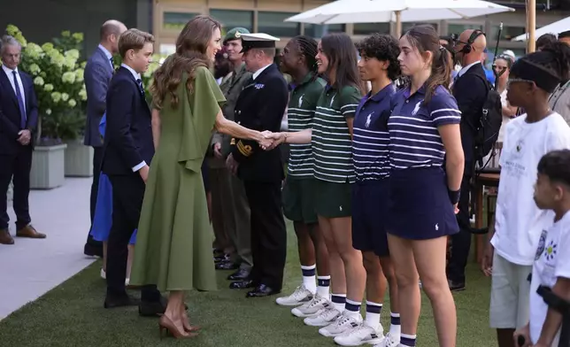 Britain's Kate, Princess of Wales, shakes hands with Court Coverer Martha Pearce as she arrives on day fourteen of the 2026 Wimbledon Championships at the All England Lawn Tennis and Croquet Club, London, England, Sunday, July 12, 2026. (Andrew Matthews/PA via AP, Pool)
