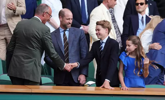 From left, German Chancellor Friedrich Merz, left, greets Britain's Prince William, Prince George and Princess Charlotte during the men's singles final between Jannik Sinner of Italy and Alexander Zverev of Germany at the Wimbledon Tennis Championships in London, England, Sunday, July 12, 2026. (Mike Egerton/PA via AP)