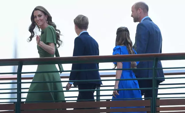 Kate, Princess of Wales wave as she walks with Prince George, Princess Charlotte, Prince William towards Centre Court for the men's singles final at Wimbledon Tennis Championships in London, Sunday, July 12, 2026. (AP Photo/Kin Cheung)