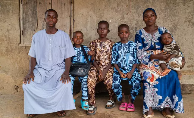 Aliyu Saheed and his wife pose for a photograph with his children that were released after being kidnapped with others from a school by al-Qaida-linked fighters in Esinele, Southwestern, Nigeria, July 17, 2026. (AP Photo/Pelumi Salako)