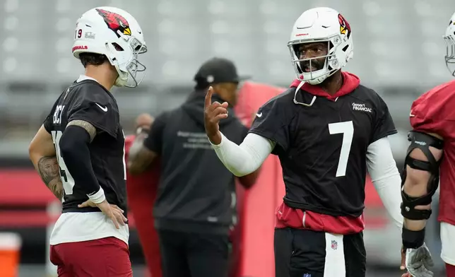Arizona Cardinals quarterback Jacoby Brissett (7) talks with Cardinals quarterback Carson Beck, left, during NFL football training camp practice, Thursday, July 23, 2026, in Glendale, Ariz. (AP Photo/Ross D. Franklin)