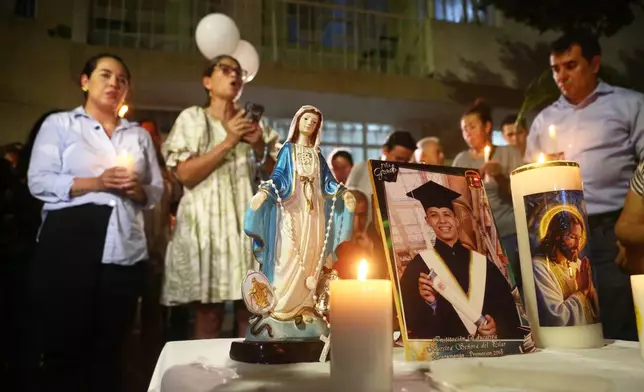 Friends and relatives hold a vigil for Johan Sebastián Durán Guerrero, a Colombian national who was fatally shot by an Immigration and Customs Enforcement officer in Maine, at his family home in Bucaramanga, Colombia, Tuesday, July 14, 2026. (AP Photo/Jaime Moreno)