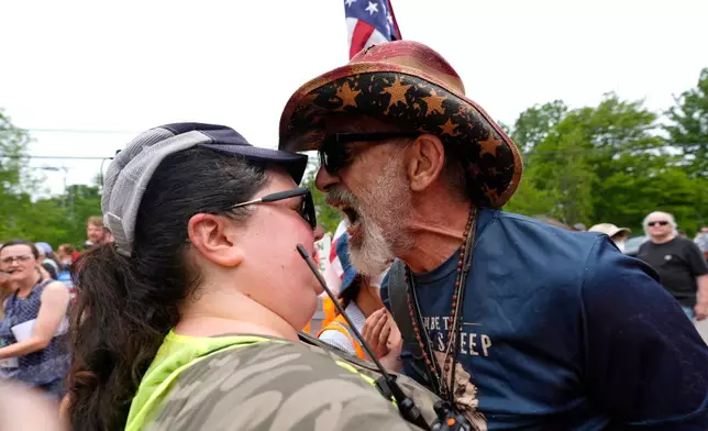 A man yells at a woman working security near a U.S. Immigration and Customs Enforcement facility in Scarborough, Maine, one day after the shooting of Johan Sebastián Durán Guerrero, Tuesday, July 14, 2026. (AP Photo/Robert F. Bukaty)