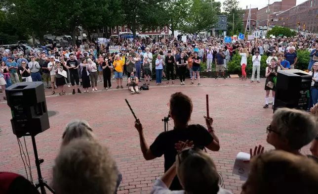 Attendees stand during a vigil after a man was shot and killed by U.S. Immigration and Customs Enforcement on Monday, July 13, 2026, in Biddeford, Maine. (AP Photo/Robert F. Bukaty)