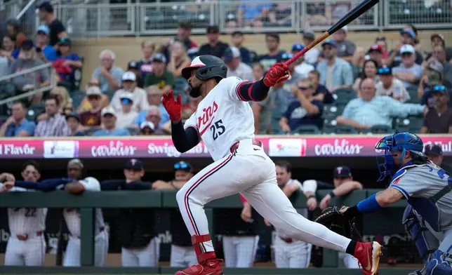 Minnesota Twins' Byron Buxton (25) advances towards first base after hitting a single in the first inning of a baseball game against the Kansas City Royals, Tuesday, July 28, 2026, in Minneapolis. (AP Photo/Joseph Scheller)