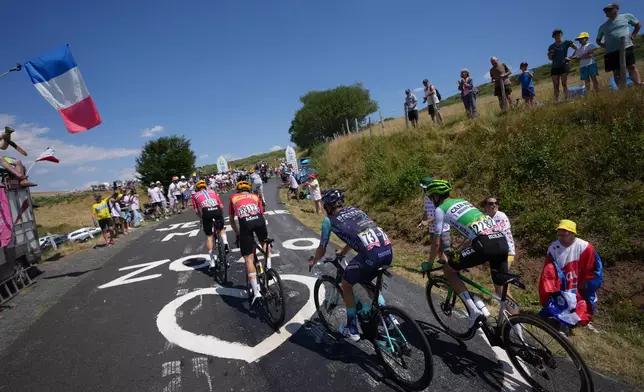 The pack rides during the tenth stage of the Tour de France cycling race with start in Aurillac and finish in Le Lioran, France, Tuesday, July 14, 2026. (AP Photo/Thibault Camus)